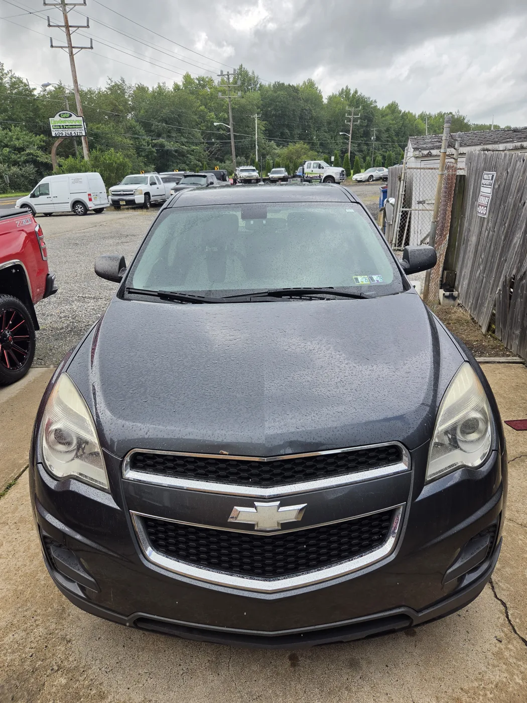 Freshly washed dark Chevrolet Equinox with a wet, glossy finish